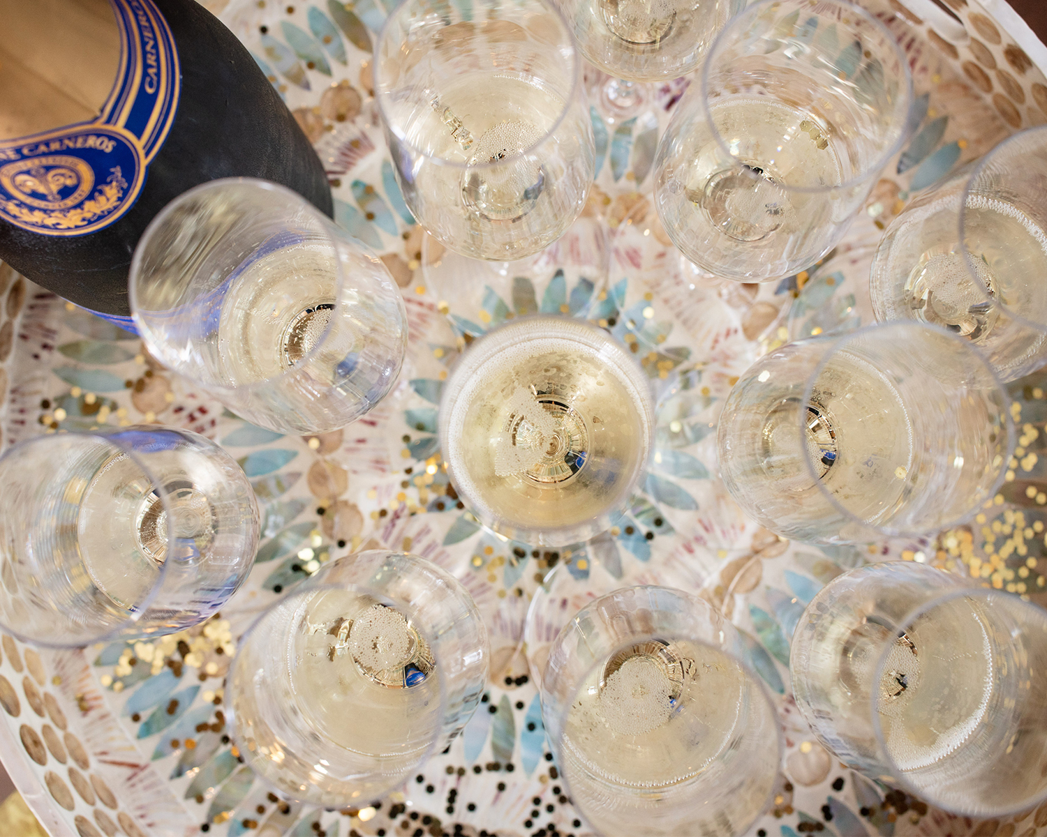 Tray of several glasses of bubbles with gold glitter
