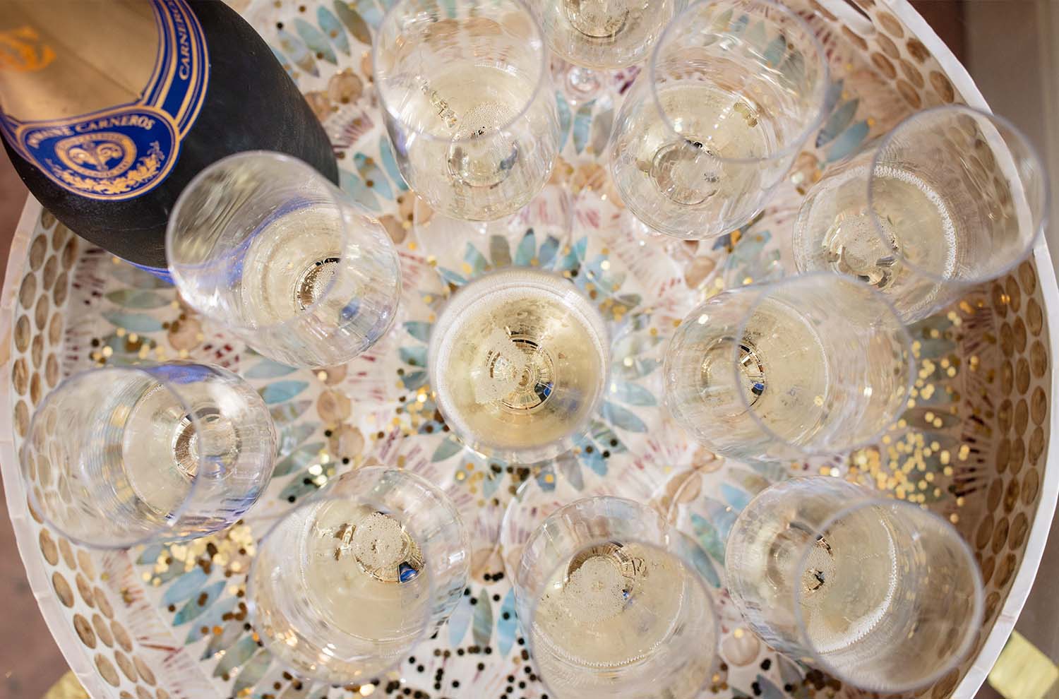 set of flutes on a tray filled with sparkling wine