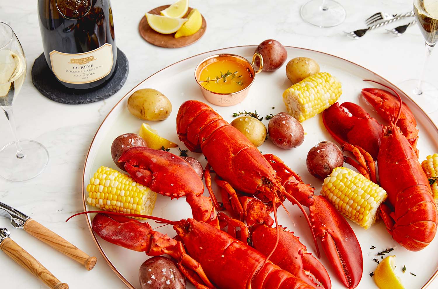 Platter of lobster and bottle of Le Reve on table