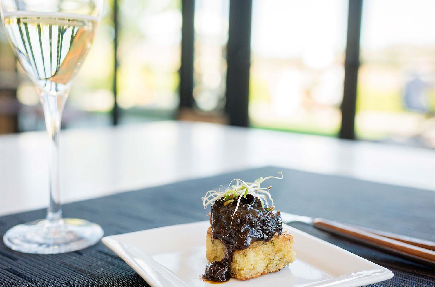 Short Rib on Cous Cous with a glass of sparkling wine