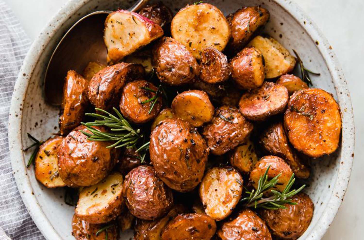 bowl of roasted potatoes with rosemary