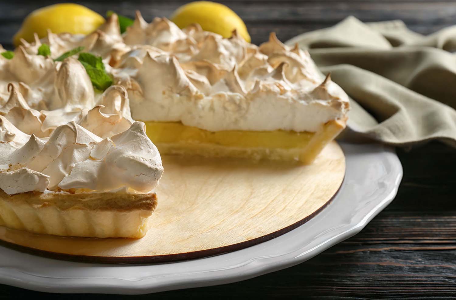 two slices of lemon lime meringue pie on serving plate