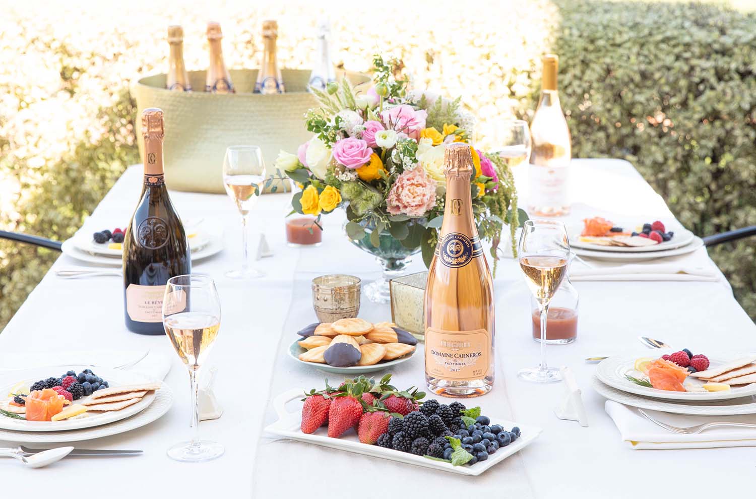 brunch table with bottle of brut rose and plates of berries