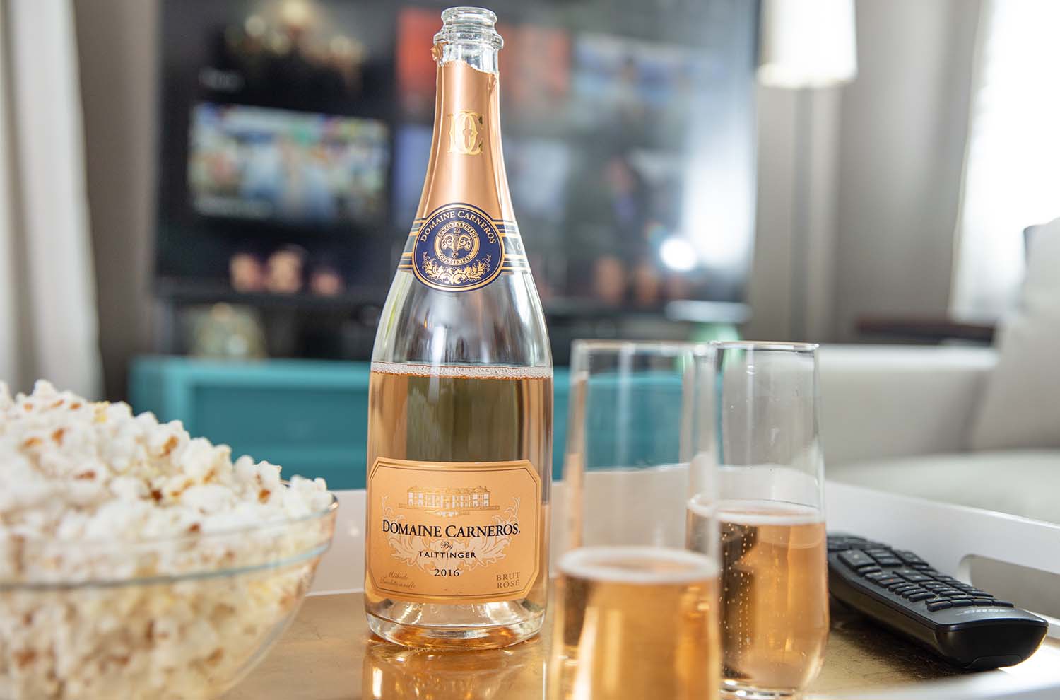 Bottle of Brut Rose with bowl of popcorn