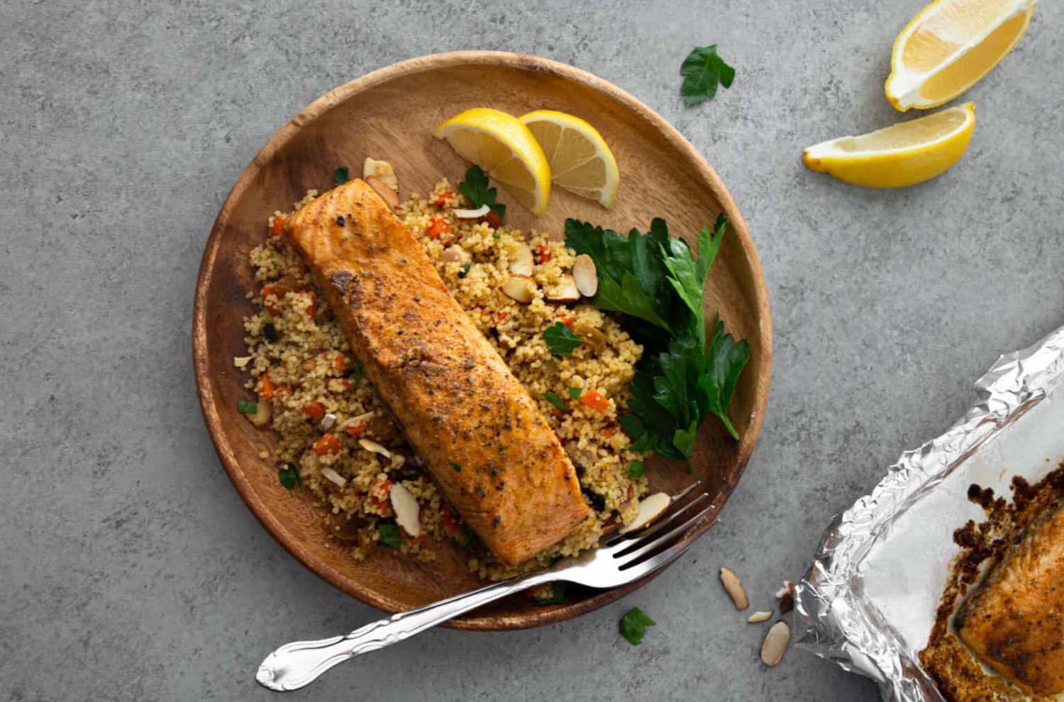 plate of Moroccan spiced salmon on cous cous with lemon