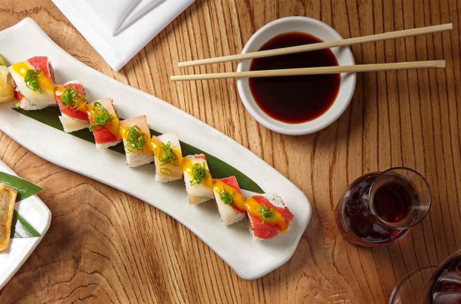 Plate of sushi roll with glass of wine