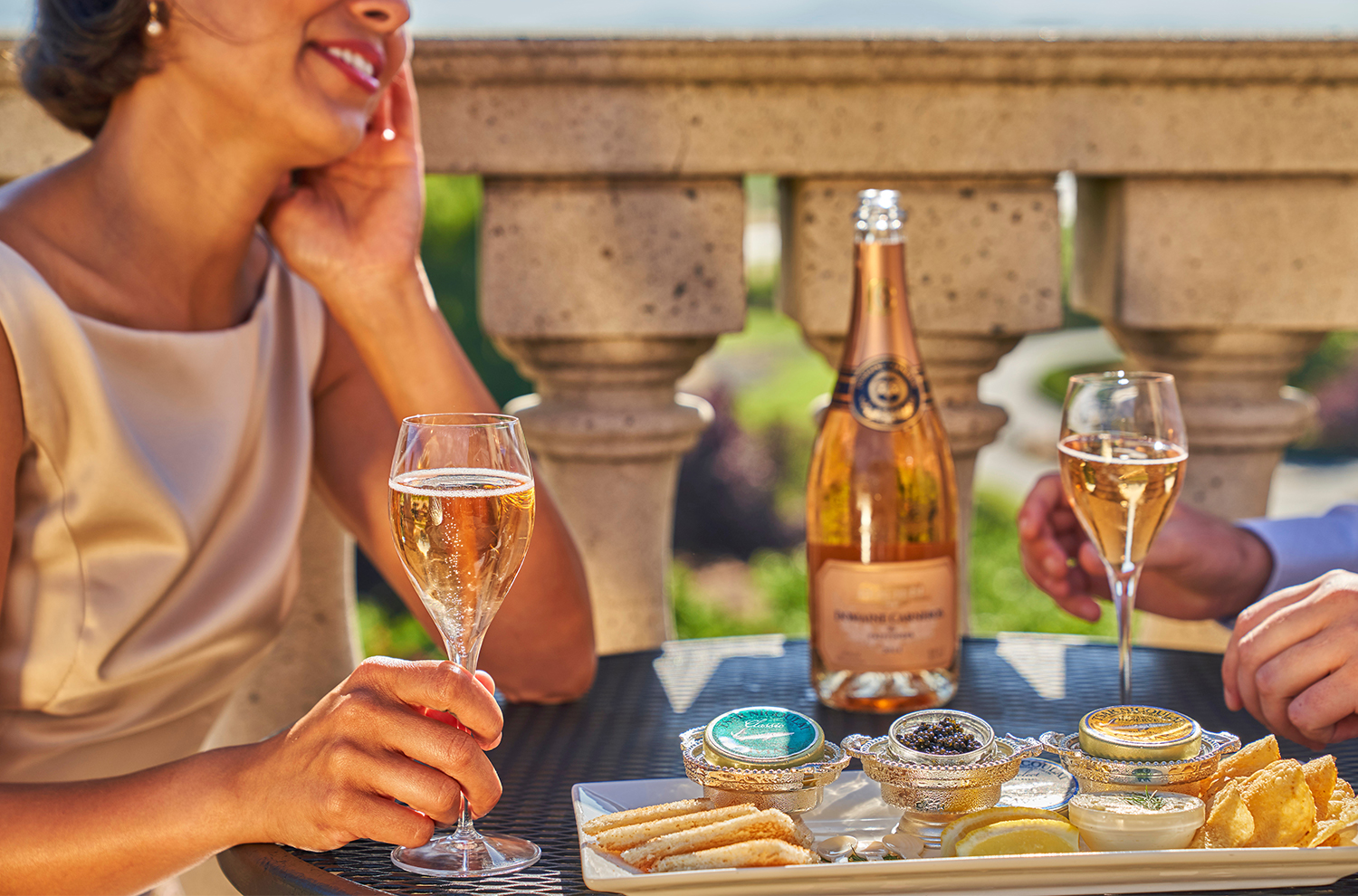 A couple enjoying sparkling wine and caviar